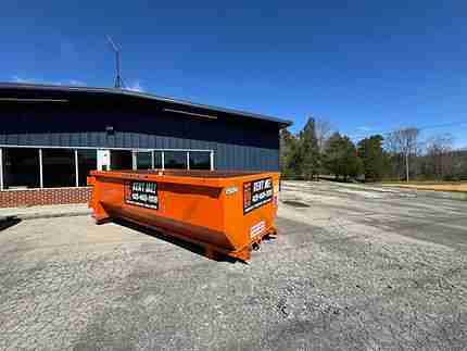 Big Orange 15-yard roll-off dumpster on asphalt